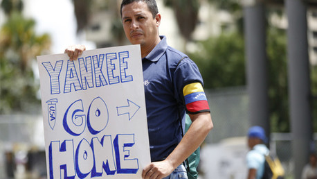 Partidario del presidente venezolano, Nicolás Maduro, sostiene un cartel que reza 