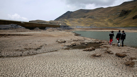 Motorcyclists stand on the dried Ajuan Khota dam, a water reserve affected by drought near La Paz, Bolivia, November 17, 2016